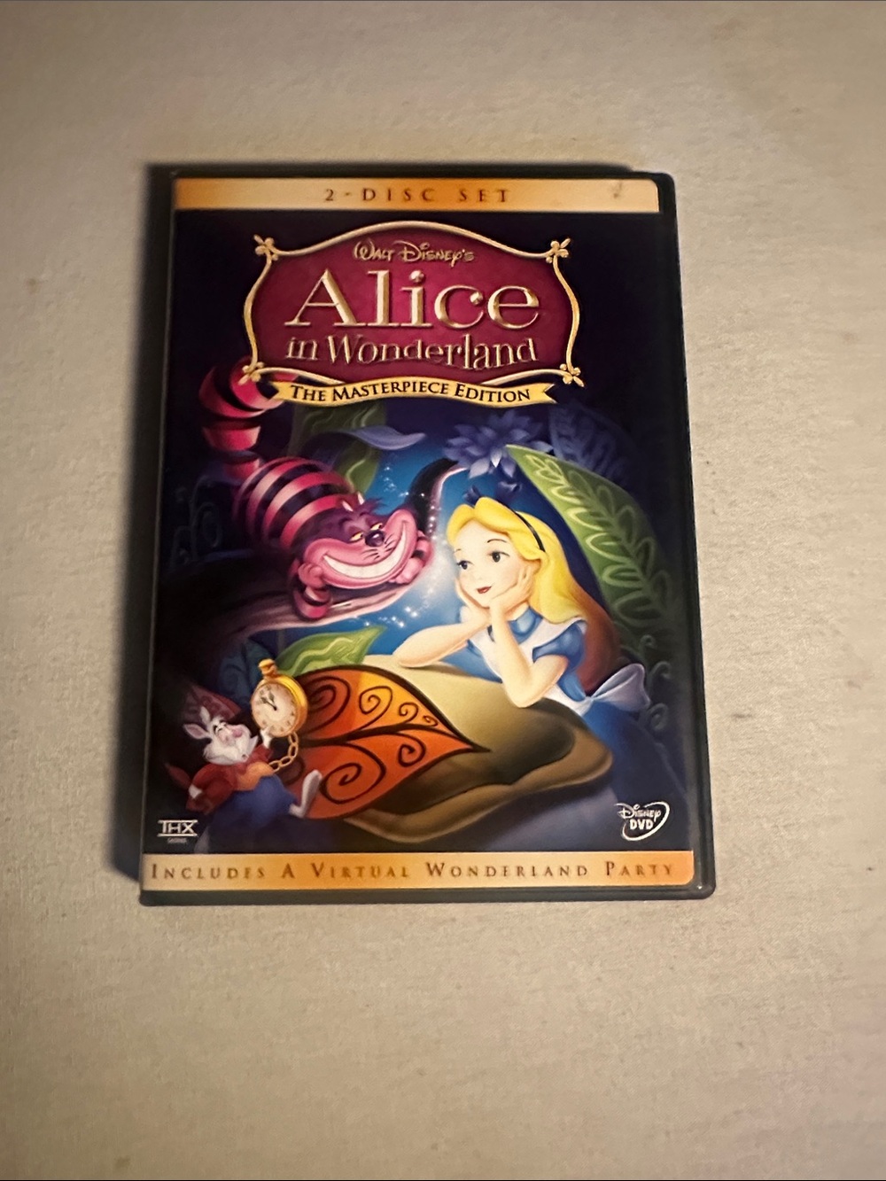 Home. Collectible Disney Alice in Wonderland DVD - Purple & Blue Cover
